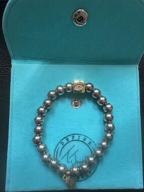 Silver Beaded Bracelet with Gold Accent and Logo Charm